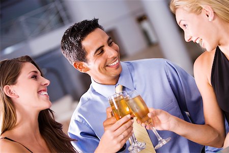 simsearch:640-03265721,k - Two young women and a mid adult man toasting Foto de stock - Sin royalties Premium, Código: 625-00901739