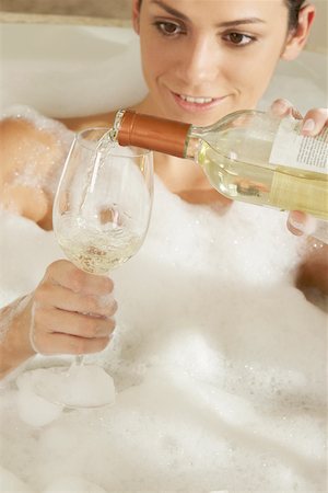 Close-up of a young woman pouring champagne in a champagne flute Stock Photo - Premium Royalty-Free, Code: 625-00901888