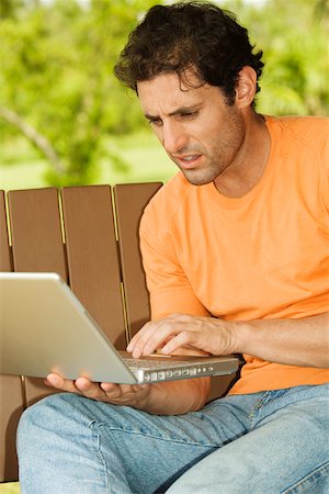 porch swing images - Close-up of a mid adult man using a laptop Foto de stock - Sin royalties Premium, Código: 625-00901995