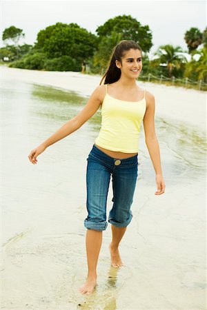 Girl wading in water on the beach Stock Photo - Premium Royalty-Free, Code: 625-00902172