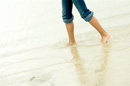 simsearch:625-00902214,k - Low section view of a girl wading in water on the beach Stock Photo - Premium Royalty-Free, Code: 625-00902219