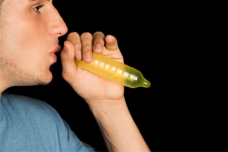 simsearch:625-01252359,k - Close-up of a young man blowing a condom Stock Photo - Premium Royalty-Free, Code: 625-00902426