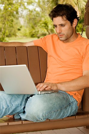 porch swing images - Close-up of a mid adult man using a laptop Foto de stock - Sin royalties Premium, Código: 625-00902438