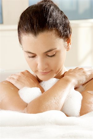 Close-up of a young woman with her eyes closed in a bathtub Stock Photo - Premium Royalty-Free, Code: 625-00902446