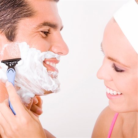 shaving man woman - Close-up of a young woman shaving a mid adult man's face Stock Photo - Premium Royalty-Free, Code: 625-00902483