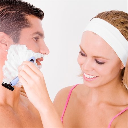 shaving man woman - Close-up of a young woman shaving a mid adult man's face Stock Photo - Premium Royalty-Free, Code: 625-00902678