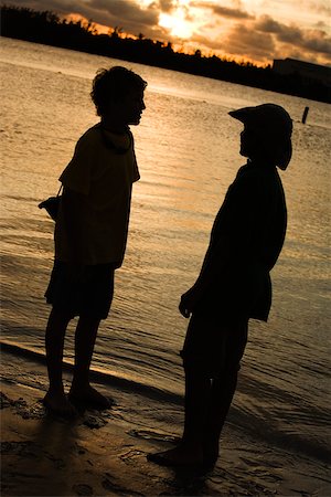 silhouette teen boy not woman not man not girl - Silhouette of two boys standing on the beach Stock Photo - Premium Royalty-Free, Code: 625-00902770