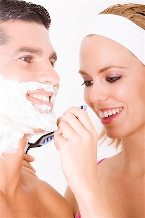 shaving man woman - Close-up of a young woman shaving a mid adult man's face Stock Photo - Premium Royalty-Free, Code: 625-00902848