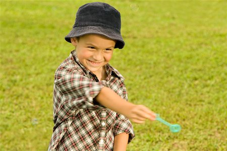 Close-up of a boy holding a bubble wand Stock Photo - Premium Royalty-Free, Code: 625-00903032