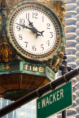 street sign and chicago - Low angle view of a clock, Chicago, Illinois, USA Stock Photo - Premium Royalty-Free, Code: 625-00903395