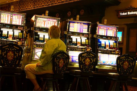 people sitting in casino - Rear view of a man sitting at a slot machine, New Orleans, Louisiana, USA Stock Photo - Premium Royalty-Free, Code: 625-00903514