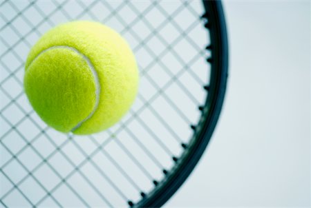 Close-up of a tennis ball with a tennis racket Stock Photo - Premium Royalty-Free, Code: 625-01037781