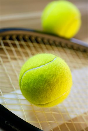 Close-up of tennis balls with a tennis racket Stock Photo - Premium Royalty-Free, Code: 625-01037839