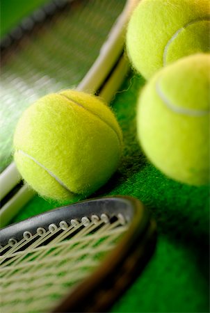 Close-up of three tennis balls and two tennis rackets Stock Photo - Premium Royalty-Free, Code: 625-01037863