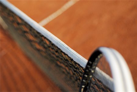 High angle view of a tennis racket and a tennis net on a tennis court Stock Photo - Premium Royalty-Free, Code: 625-01037892
