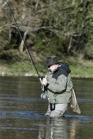 Fly fishing in cowboy hat Stock Photos - Page 1 : Masterfile