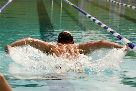 simsearch:625-01038267,k - High angle view of a mid adult man swimming the butterfly stroke Stock Photo - Premium Royalty-Free, Code: 625-01038052