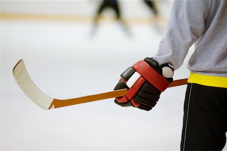 simsearch:625-01038051,k - Mid section view of an ice hockey player holding an ice hockey stick Stock Photo - Premium Royalty-Free, Code: 625-01038063