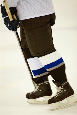 simsearch:625-01038051,k - Low section view of an ice hockey player holding an ice hockey stick Stock Photo - Premium Royalty-Free, Code: 625-01038079