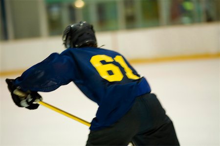 simsearch:625-01038051,k - Rear view of an ice hockey player playing ice hockey Stock Photo - Premium Royalty-Free, Code: 625-01038070