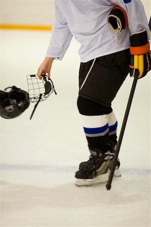 simsearch:625-01038051,k - Side profile of an ice hockey player holding an ice hockey skate and a helmet Stock Photo - Premium Royalty-Free, Code: 625-01038107