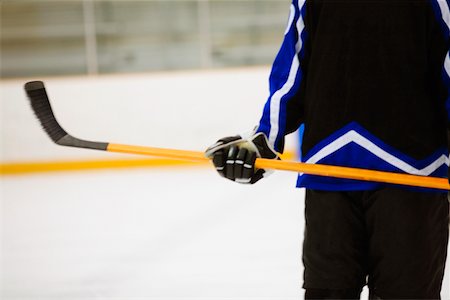simsearch:625-01038051,k - Mid section view of an ice hockey player holding an ice hockey stick Stock Photo - Premium Royalty-Free, Code: 625-01038140