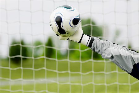 soccer goalie hands - Close-up of a goalie's hand making a save Stock Photo - Premium Royalty-Free, Code: 625-01038354