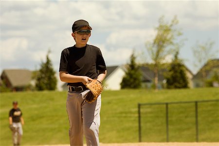 Baseball player walking in a baseball field Stock Photo - Premium Royalty-Free, Code: 625-01038410