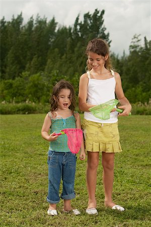 Two girls looking at a butterfly net Stock Photo - Premium Royalty-Free, Code: 625-01038712