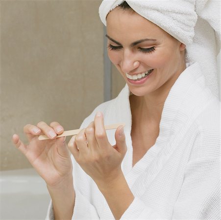 simsearch:625-01097322,k - Close-up of a young woman filing her fingernails Stock Photo - Premium Royalty-Free, Code: 625-01038743