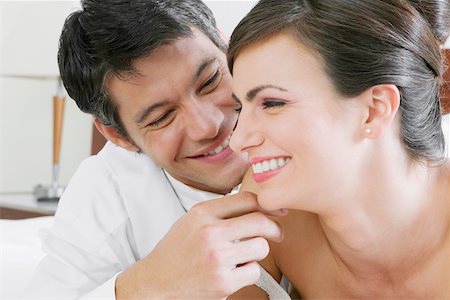 Close-up of a newlywed couple smiling Stock Photo - Premium Royalty-Free, Code: 625-01039017