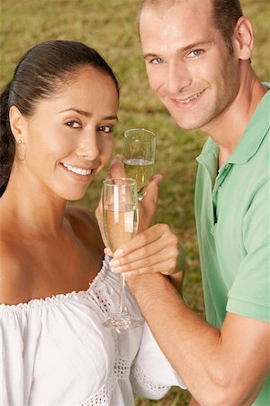 Portrait of a young couple holding champagne flutes Stock Photo - Premium Royalty-Free, Code: 625-01039106