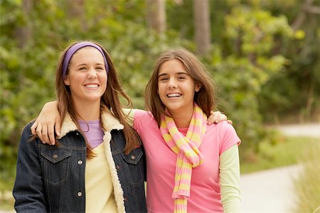 Portrait of a girl with her arm around her friend and smiling Stock Photo - Premium Royalty-Free, Code: 625-01039178