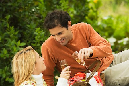 Mid adult man and a young woman toasting with champagne Stock Photo - Premium Royalty-Free, Code: 625-01039201