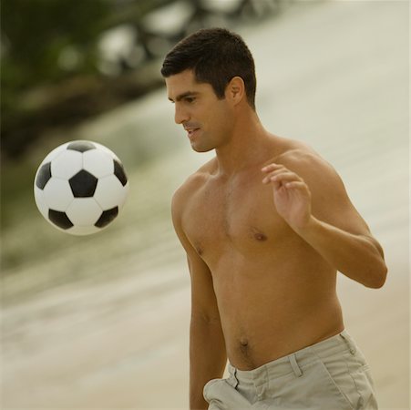 simsearch:625-01098120,k - Close-up of a mid adult man playing with a soccer ball on the beach Stock Photo - Premium Royalty-Free, Code: 625-01039309