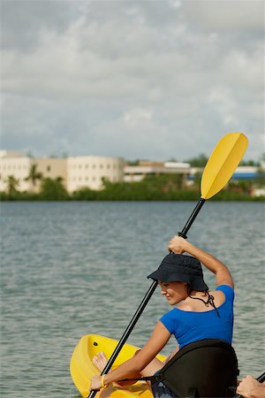 Rear view of a young woman sitting in a kayak Stock Photo - Premium Royalty-Free, Code: 625-01039502