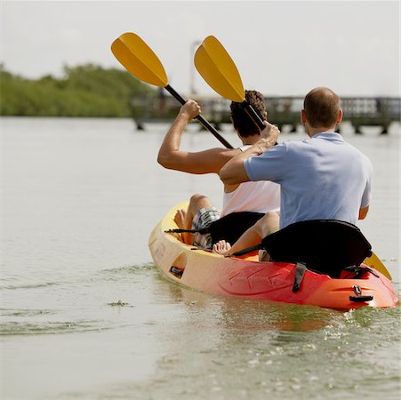 Rear view of two young men kayaking Stock Photo - Premium Royalty-Free, Code: 625-01039677