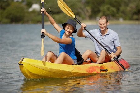 Portrait of a teenage girl and a young man kayaking Stock Photo - Premium Royalty-Free, Code: 625-01039766