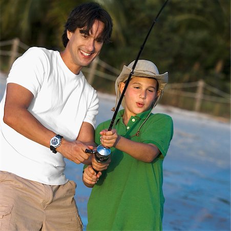Close-up of a father and his son fishing Stock Photo - Premium Royalty-Free, Code: 625-01039763