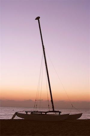 sailboat silhouette - Silhouette of a sailboat on the beach Stock Photo - Premium Royalty-Free, Code: 625-01039841