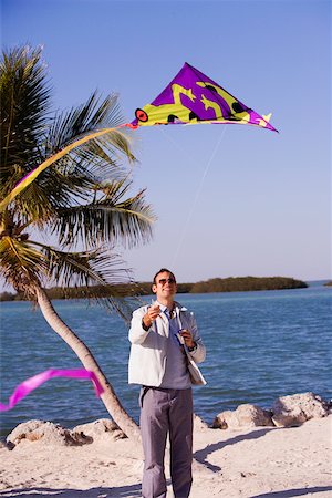 Mid adult man flying a kite Stock Photo - Premium Royalty-Free, Code: 625-01039917
