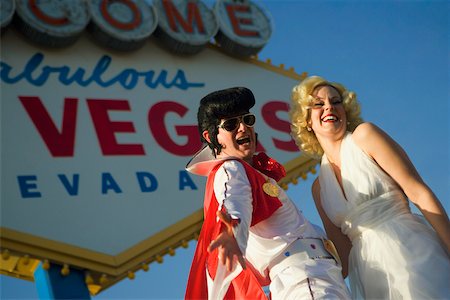elvis - Mid adult man and a mid adult woman dressed in costumes, Las Vegas, Nevada, USA Foto de stock - Sin royalties Premium, Código: 625-01040261
