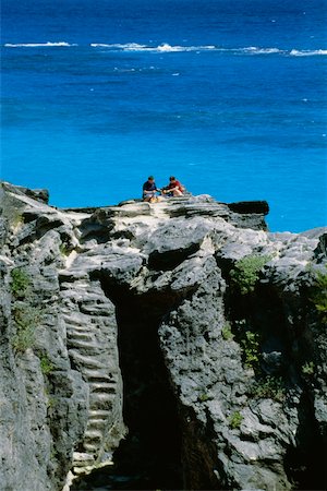 A couple holidaying on the rocks, Atwood bay beach, Bermuda Stock Photo - Premium Royalty-Free, Code: 625-01040425