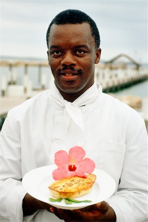 Phillip Bethel holding a garnished dish, Abaco, Bahamas Stock Photo - Premium Royalty-Free, Code: 625-01040492
