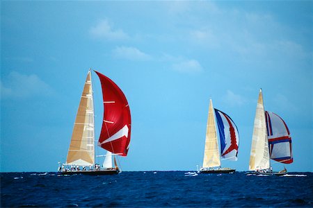 st martin - Sailboats participate in the Heiniken Regatta on the Dutch side of the island of St. Maarten in the Caribbean Foto de stock - Sin royalties Premium, Código: 625-01040929