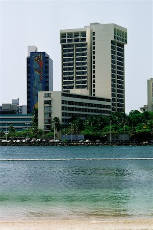 View to commercial buildings from a beach, San Juan, Puerto Rico Stock Photo - Premium Royalty-Free, Code: 625-01040975