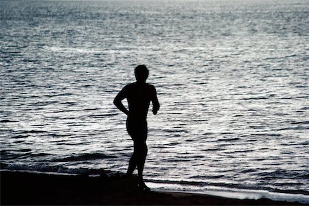 dark people running - Silhouette of a man against the sea, Puerto Rico Stock Photo - Premium Royalty-Free, Code: 625-01040983