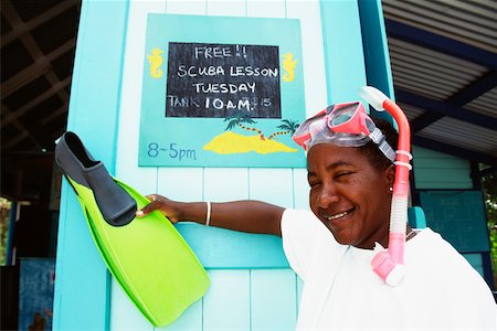 A lady poses in front of a notice while holding a flipper, Port Elizabeth Stock Photo - Premium Royalty-Free, Code: 625-01041128