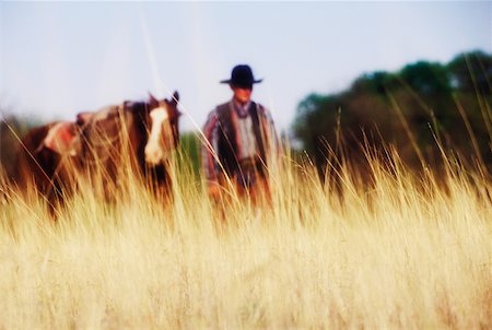 Cowboy standing with a horse, Texas, USA Stock Photo - Premium Royalty-Free, Code: 625-01094850