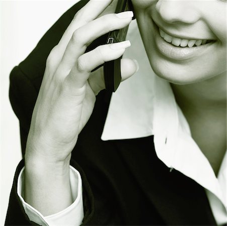 simsearch:625-01093712,k - Close-up of a businesswoman talking on a mobile phone and smiling Stock Photo - Premium Royalty-Free, Code: 625-01095400